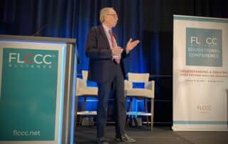 Dr. Harch on stage presenting at FLCCC Conference
