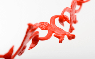 Red DNA strand with plastic monkey intertwined