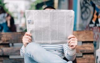 Photograph of man reading a newspaper