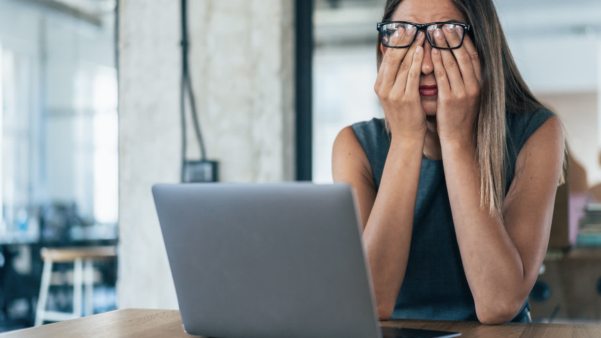 Person experiencing fatigue at a laptop